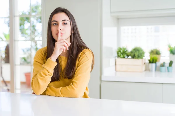 Beautiful Young Woman Wearing Yellow Sweater Asking Quiet Finger Lips — Stock Photo, Image