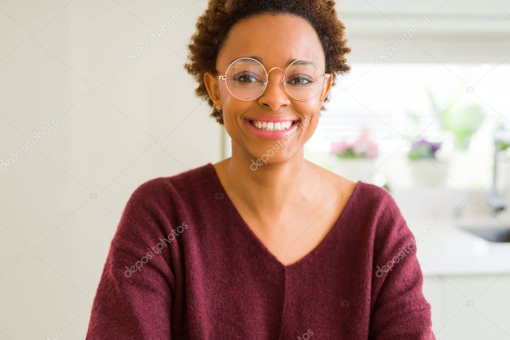 Beautiful young african woman with afro hair wearing glasses