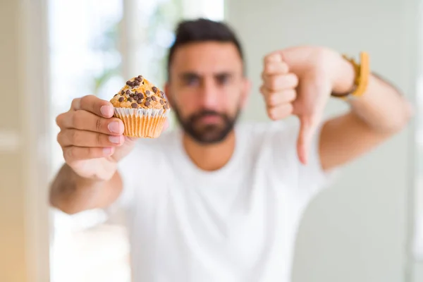 Stilig Spansktalande Man Äta Chips Choklad Muffin Med Arga Ansikte — Stockfoto
