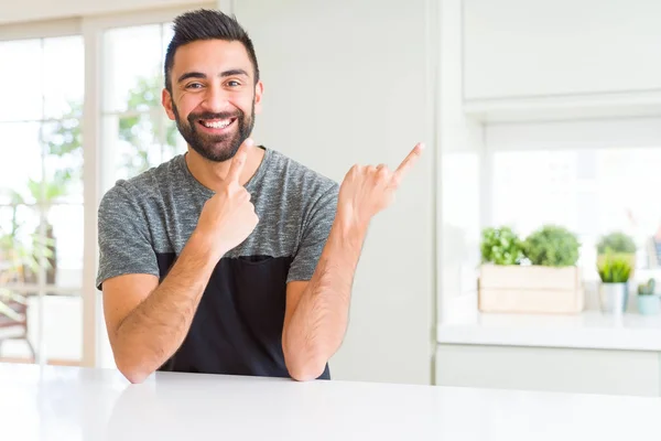 カジュアルな シャツを着て家でハンサムなヒスパニック系の男は笑みを浮かべて つの手と指で指しているカメラ目線 — ストック写真