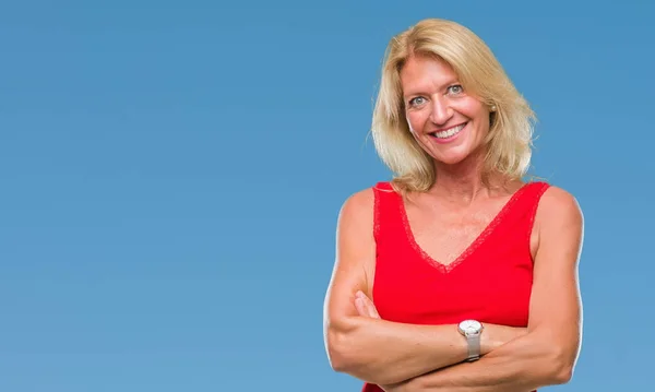 Middle age blonde woman over isolated background happy face smiling with crossed arms looking at the camera. Positive person.