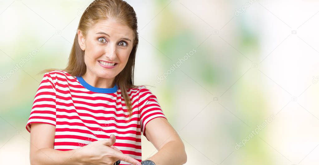 Middle age mature woman wearing casual t-shirt over isolated background In hurry pointing to watch time, impatience, upset and angry for deadline delay