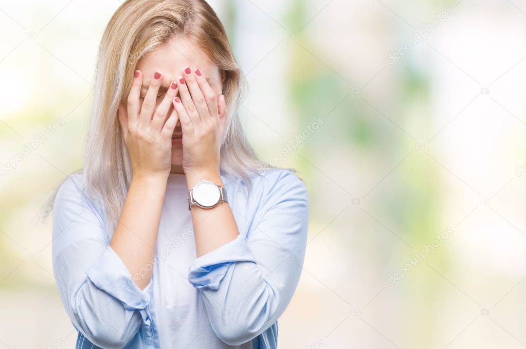 Young blonde woman over isolated background with sad expression covering face with hands while crying. Depression concept.