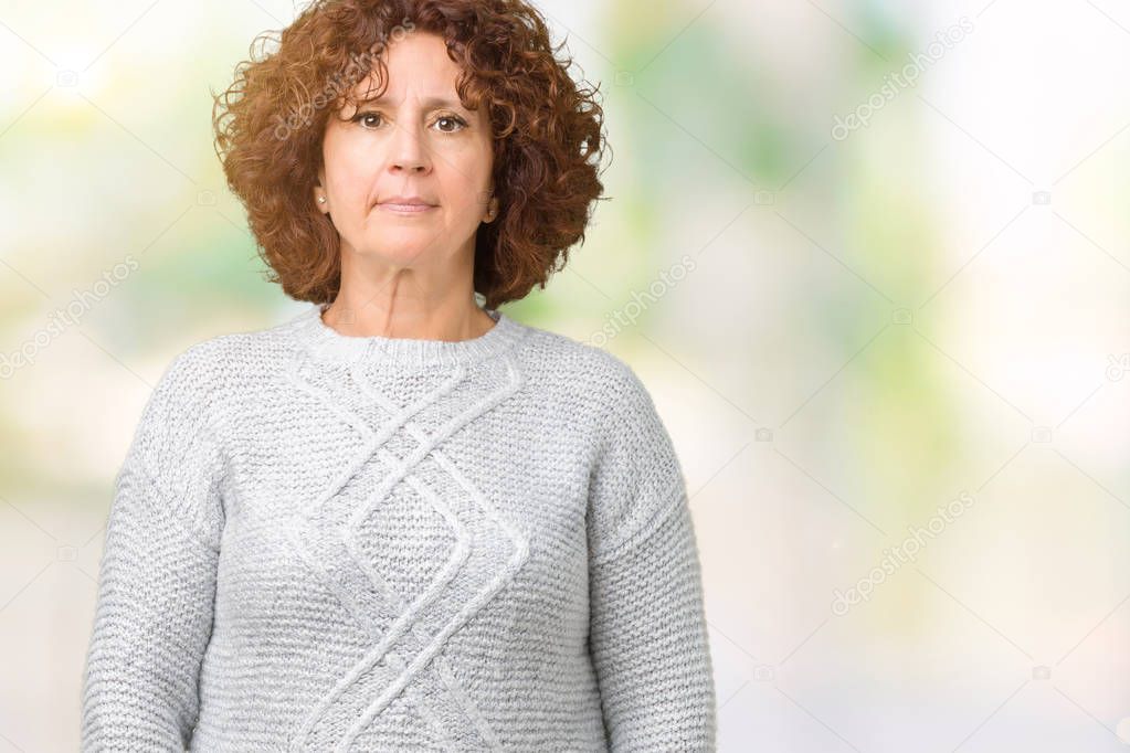 Beautiful middle ager senior woman wearing winter sweater over isolated background Relaxed with serious expression on face. Simple and natural looking at the camera.