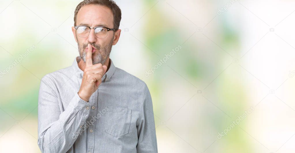 Handsome middle age elegant senior man wearing glasses over isolated background asking to be quiet with finger on lips. Silence and secret concept.