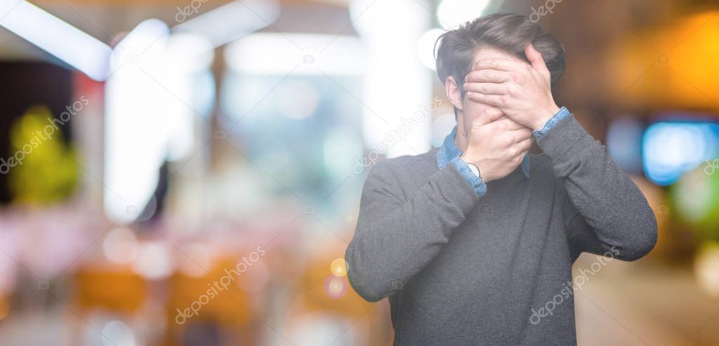 Young handsome elegant man over isolated background Covering eyes and mouth with hands, surprised and shocked. Hiding emotion