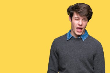 Genç yakışıklı zarif adam seksi bir ifadeyle, neşeli ve mutlu yüzünü kameraya bakarak göz kırpıyor izole arka plan üzerinde.