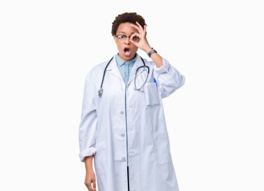 Sürpriz yüz, göz parmaklarının arasından seyir ile ok jest yapıyor izole arka plan üzerinde tıbbi ceket giyen genç Afro-Amerikan doktor kadın şok. İmansız ifade.