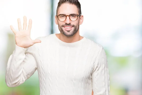 Young handsome man wearing glasses over isolated background showing and pointing up with fingers number five while smiling confident and happy.
