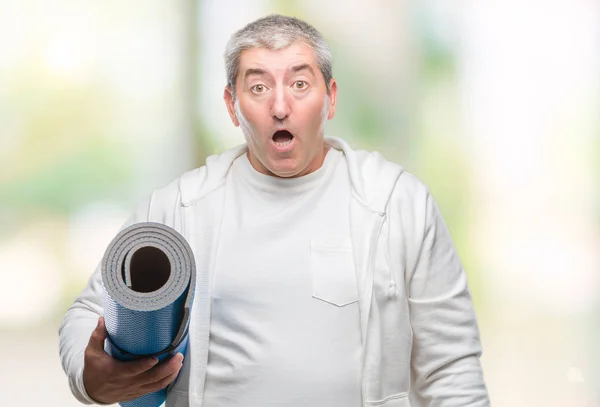 Handsome Senior Man Holding Yoga Mat Isolated Background Scared Shock — Stock Photo, Image