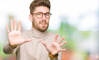 Şokta bağırarak korkuyor ve dehşet korku ifade dur hareketi el ile ile gözlüklü genç yakışıklı iş adamı. Panik kavramı.