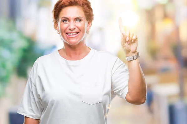 Atrractive Senior Caucasian Redhead Woman Isolated Background Showing Pointing Finger — Stock Photo, Image