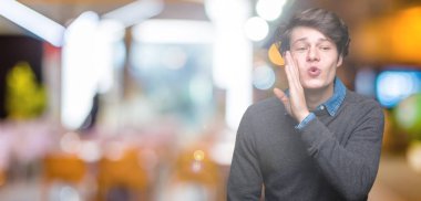 Genç yakışıklı zarif adam izole arka plan üzerinde el gizli söylenti söylüyor Ağızdan kötü amaçlı konuşma konuşma fısıldayan