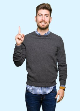 Başarılı fikirle parmak işaret yakışıklı zarif delikanlı. Çıktıktan ve mutlu. Bir numara.