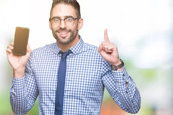 Young Business Man Showing Smartphone Screen Isolated Background Surprised Idea — Stock Photo, Image