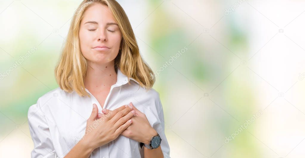 Beautiful young business woman over isolated background smiling with hands on chest with closed eyes and grateful gesture on face. Health concept.