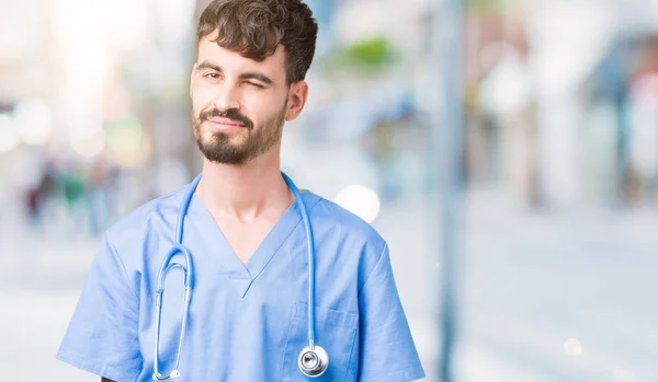 Young Handsome Nurse Man Wearing Surgeon Uniform Isolated Background Winking — Stock Photo, Image