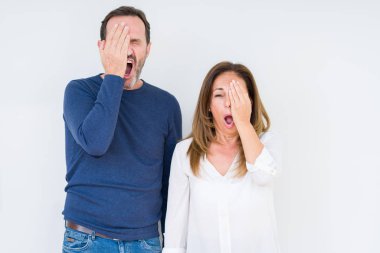 Güzel orta yaş kaç aşk yorgun esneme izole arka plan üzerinde içinde yarım yüz, göz ve ağız el ile kapsayan. Acı yüzü acıyor.