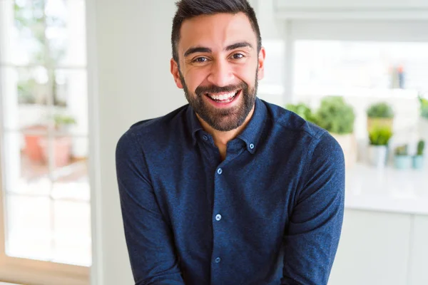 Handsome man smiling cheerful with a big smile on face showing teeth, positive and happy expression