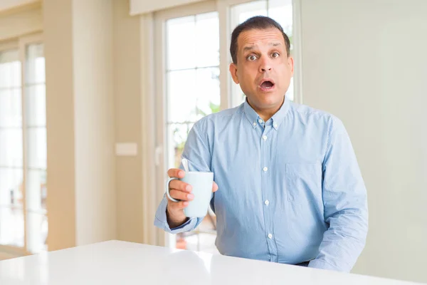 Middle Age Man Drinking Coffee Morning Home Scared Shock Surprise — Stock Photo, Image