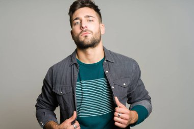 Yakışıklı delikanlı possing ve modelleme gri izole arka plan üzerinde