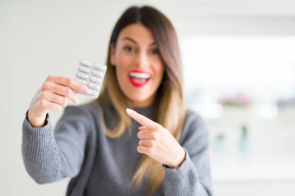 Giovane Bella Donna Possesso Pillole Farmaceutiche Casa Molto Felice Indicando — Foto Stock