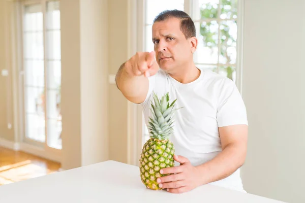Middle Age Man Eating Fresh Tropical Pineapple Home Pointing Finger — Stock Photo, Image