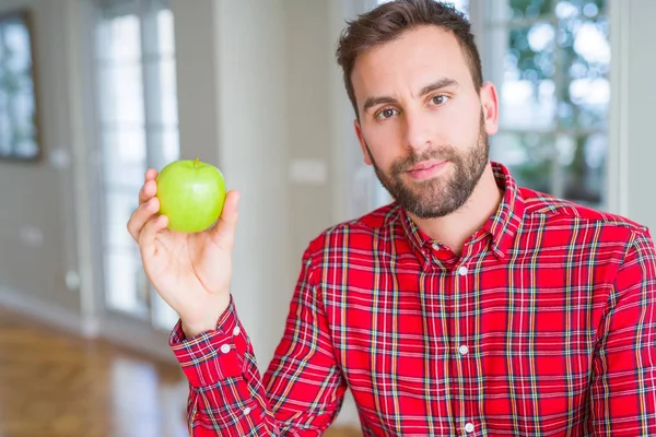 Schöner Mann Isst Frischen Gesunden Grünen Apfel Mit Selbstbewusstem Gesichtsausdruck — Stockfoto