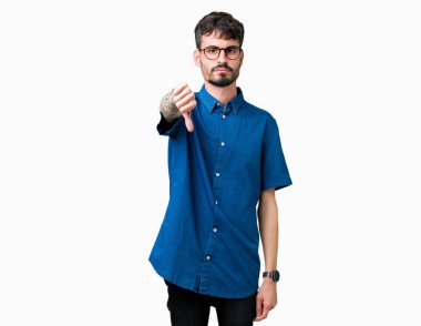 Mutsuz ve kızgın ret gösterilen ve başparmak aşağı hareketi ile negatif seyir izole arka plan üzerinde gözlük takan yakışıklı delikanlı. Kötü ifade.