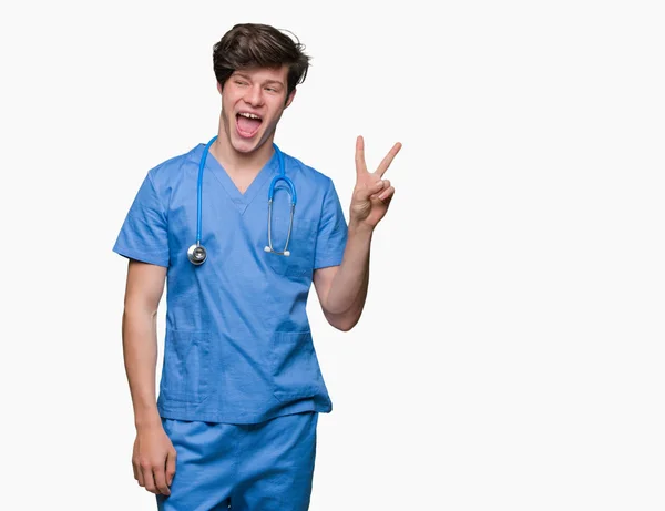 Joven Médico Vistiendo Uniforme Médico Sobre Fondo Aislado Sonriendo Con —  Fotos de Stock