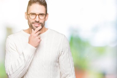 Emin çapraz kollar ve çeneme kaldırdı el ile gülümseme ile kameraya bakarak izole arka plan üzerinde gözlük takan yakışıklı delikanlı. Pozitif düşünce.