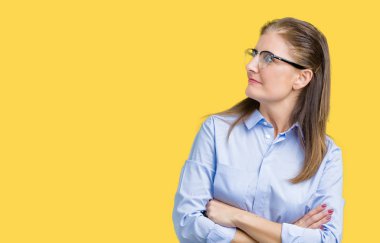 İkna ve kendine güvenen güzel orta yaş olgun iş kadını tarafına silahlarla seyir gülümseyen izole arka plan üzerinde gözlük takan geçti