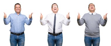 Arap orta yaş adam izole arka plan başarı işareti el ile pozitif jest yapıyor bileşimi başparmak gülümseyen ve mutlu. Neşeli bir ifadeyle, kazanan jest kameraya bakıyor.