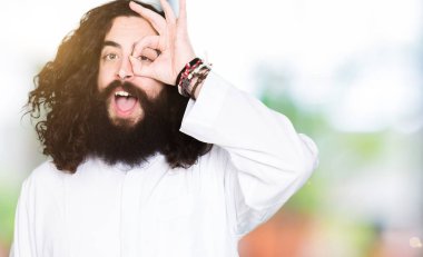 Gülümseyen, parmakları ile mutlu yüz üzerinden seyir göz el ile ok jest yapıyor Tanrı aşkına giyinen adam.