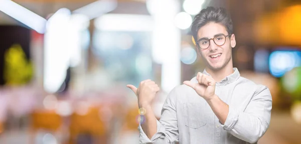 Jonge Knappe Man Met Bril Geïsoleerd Achtergrond Wijzend Naar Achterzijde — Stockfoto