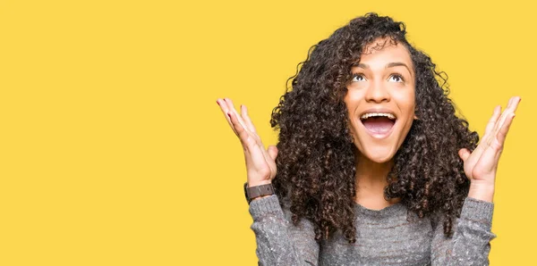 Young Beautiful Woman Curly Hair Wearing Grey Sweater Celebrating Crazy — Stock Photo, Image