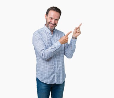 Yakışıklı orta yaş zarif komuta sizde gülümseyen ve iki elleri ve parmakları ile tarafına işaret kamera bakarak izole arka plan üzerinde.