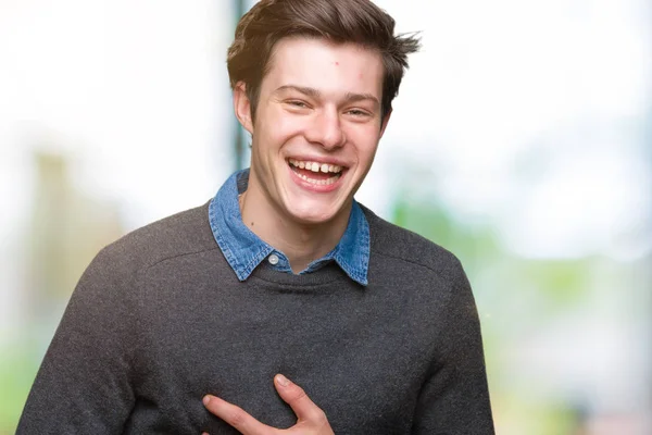 Young handsome elegant man over isolated background Smiling and laughing hard out loud because funny crazy joke. Happy expression.