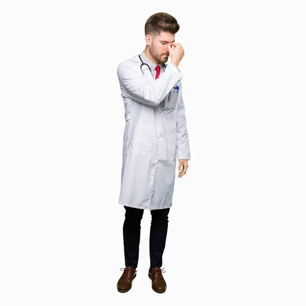 Young Handsome Doctor Man Wearing Medical Coat Tired Rubbing Nose — Stock Photo, Image