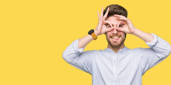 Young Handsome Man Doing Gesture Binoculars Sticking Tongue Out Eyes — Stock Photo, Image