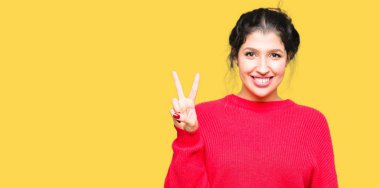 Kırmızı kazak ve gösterilen ve parmakları ile işaret topuz giyen genç güzel kadın ikincisi ise kendinden emin ve mutlu gülümseyerek.