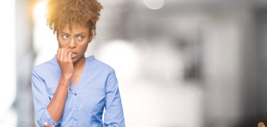 Güzel genç Afro-Amerikan iş kadın yüzünden stresli ve gergin elle çivi ısırma ağzına bakarak izole arka plan. Anksiyete sorunu.