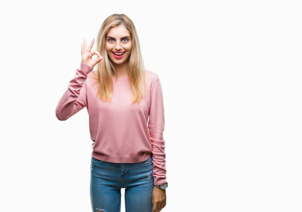 若い美しい金髪女性の孤立した背景を浮かべて手と指で サインをしている肯定的な上ピンク冬セーターを着ています 成功した式 — ストック写真