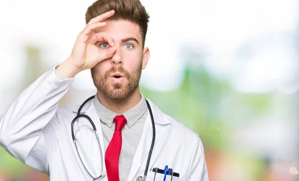 Young Handsome Doctor Man Wearing Medical Coat Doing Gesture Shocked — Stock Photo, Image