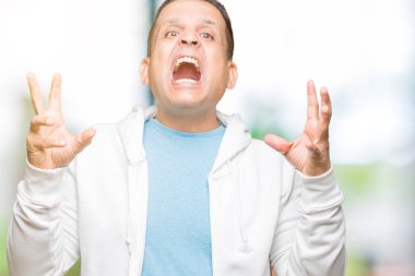 Üzerinde sweatshirt giyen orta yaş Arap adam arka plan deli kutluyor izole ve crazy arms ile başarı için kaldırdı ve heyecanlı çığlık gözler kapalı. Kazanan kavramı