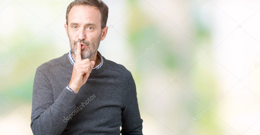 Handsome middle age senior man wearing a sweater over isolated background asking to be quiet with finger on lips. Silence and secret concept.