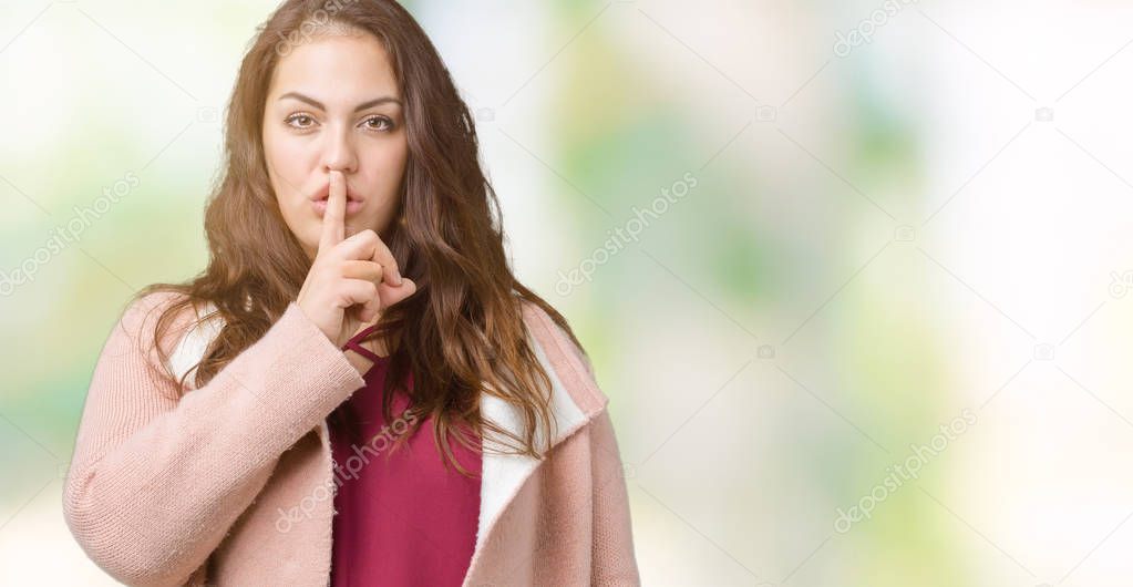 Beautiful plus size young woman wearing winter coat over isolated background asking to be quiet with finger on lips. Silence and secret concept.
