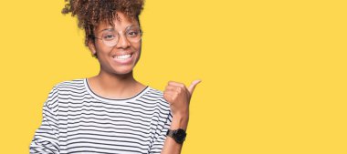 Güzel genç Afro-Amerikan kadın arıyorum ve başparmak yanında yukarıyı mutlu yüz ile gülümseyen izole arka plan üzerinde gözlük.