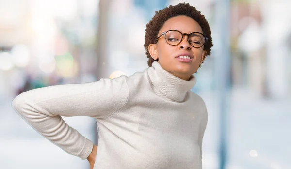 Young beautiful african american woman wearing glasses over isolated background Suffering of backache, touching back with hand, muscular pain