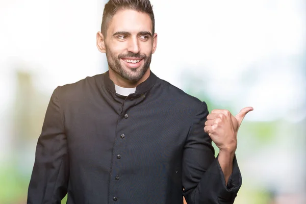 Young Christian Priest Isolated Background Smiling Happy Face Looking Pointing — Stock Photo, Image